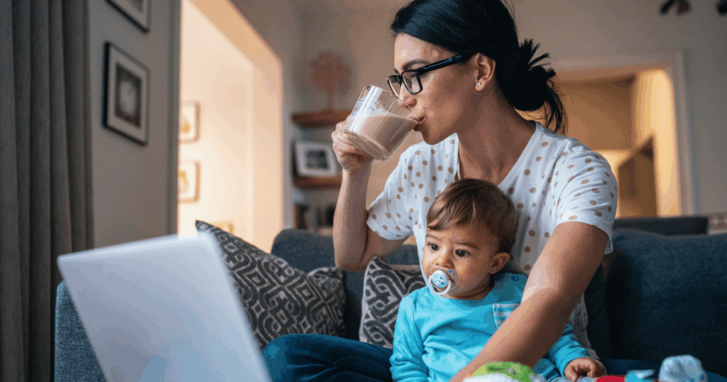Woman in front of computer with baby