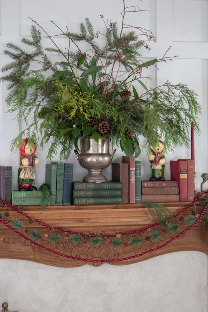 Christmas greenery mantel display in vintage ice bucket